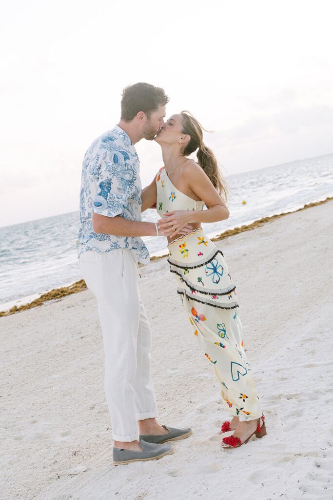 kissing couple on mexico beach welcome party