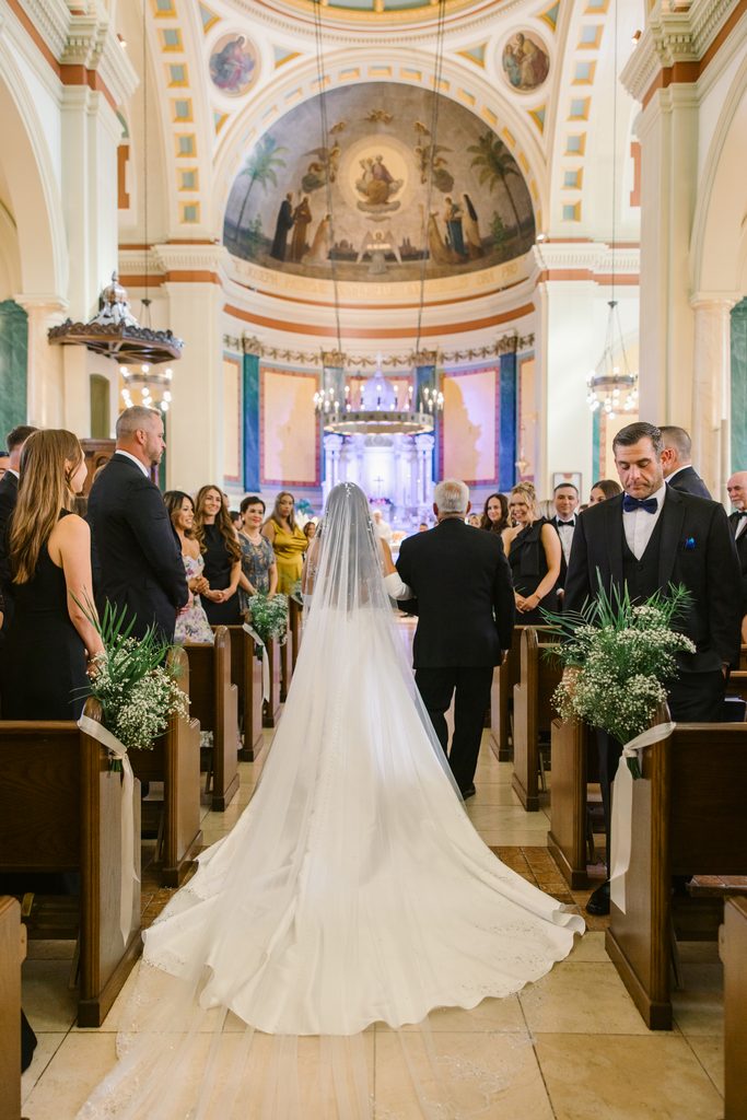 bride and father walking down church aisle